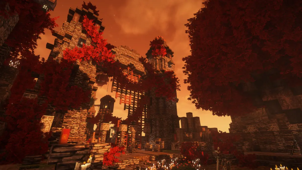 A ruined keep wrapped in red autumn foliage under a burning sky.